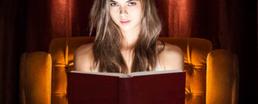 spooky girl reading a horror novel