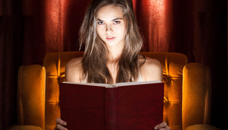 spooky girl reading a horror novel