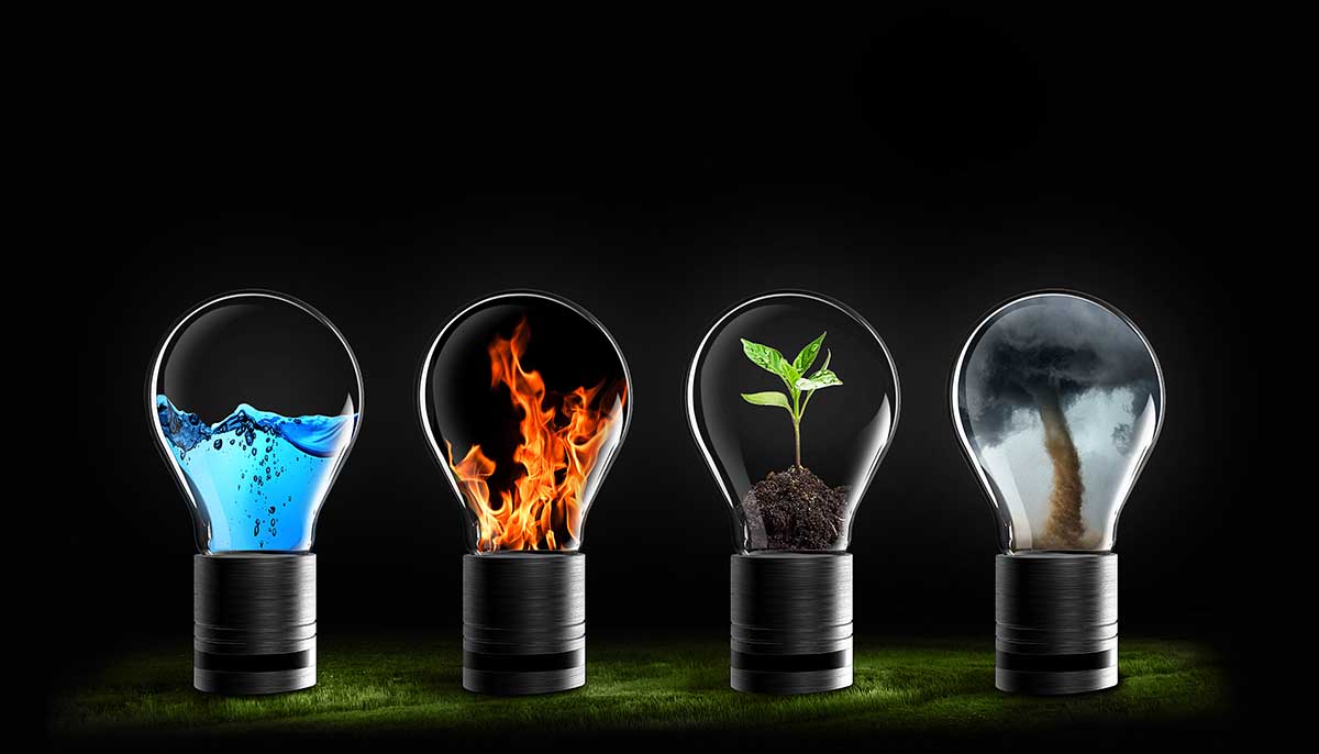 The four elements of water, fire, earth and air contained in lightbulbs against a black background