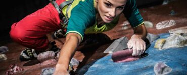 Athletic woman climbing an indoor rock wall