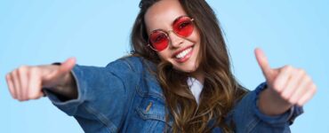 Optimistic woman sees the world through rose colored glasses