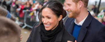 Prince Harry and his fiance Meghan Markle greet schoolchildren on their arrival at Cardiff Castle.