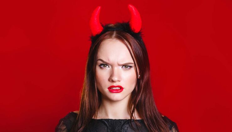 a woman is dressed in a devil halloween costume