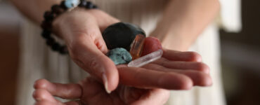 Close up photo of a woman holding crystals in her hands.