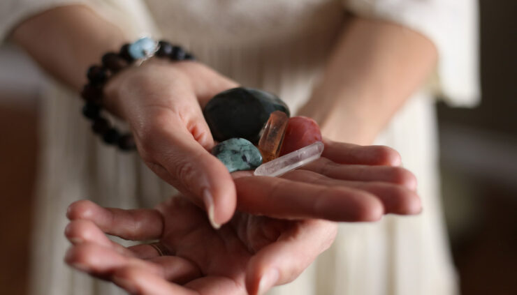 Close up photo of a woman holding crystals in her hands.