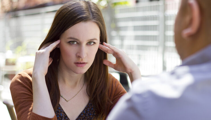 A woman on a date looks edgy and annoyed.