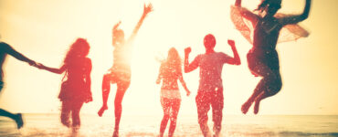 Silhouettes of people playing on the beach