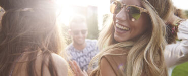 A woman at a party smiles at the camera.