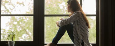 Woman staring out of a window.