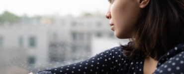 Asian woman stares out window