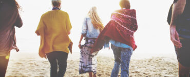 Friends walking on beach