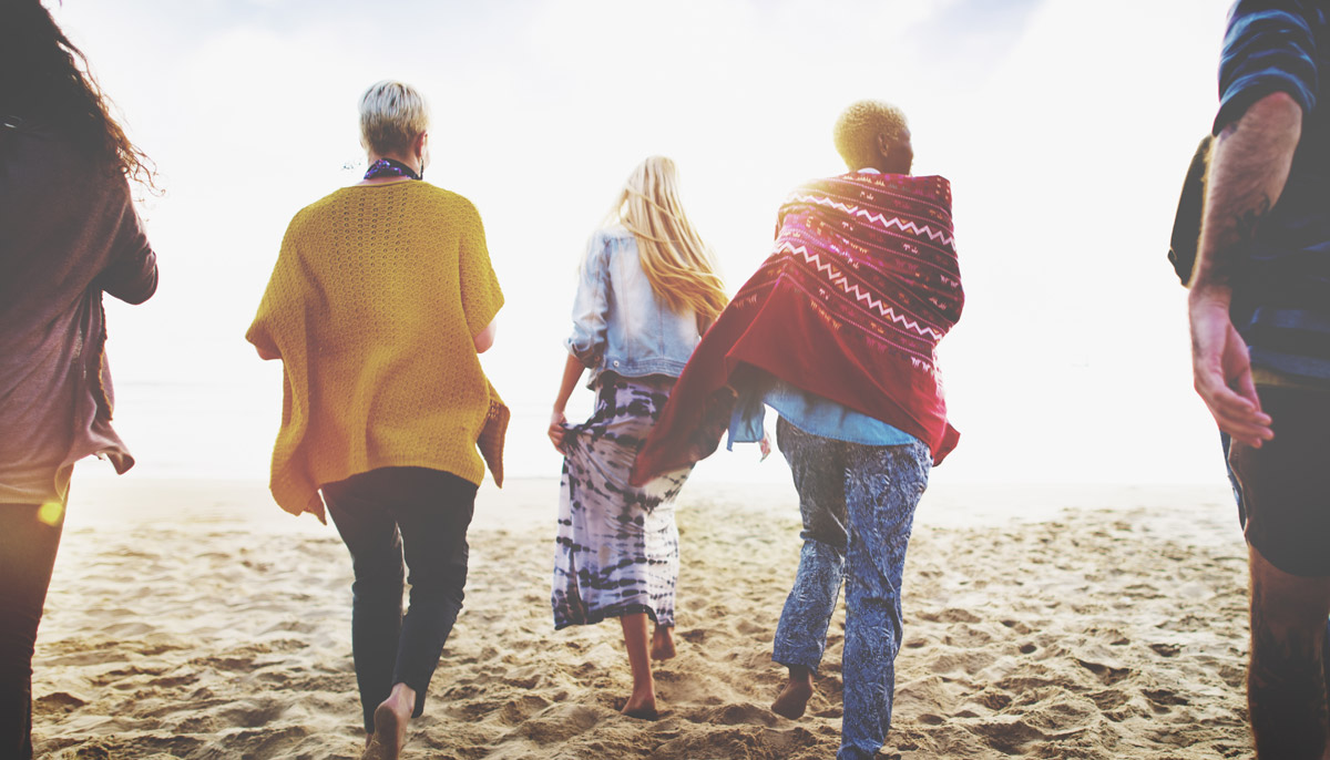 Friends walking on beach