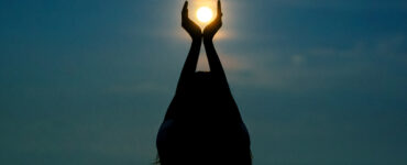 Woman with hands around moon