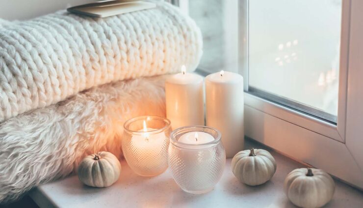 Cozy room with candles and blankets