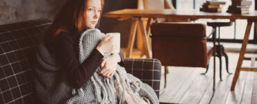 Woman with blanket and tea