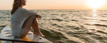 Woman on paddle board on ocean